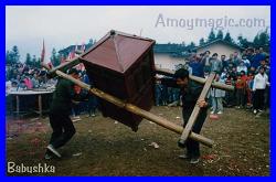 Wrestling the 300 pound card (with heavy Pusa Idol inside).  Last guy of the day to survive gets the beautiful Hakka maiden!  Photo taken at annual Hakka festival in Changting, West Fujian